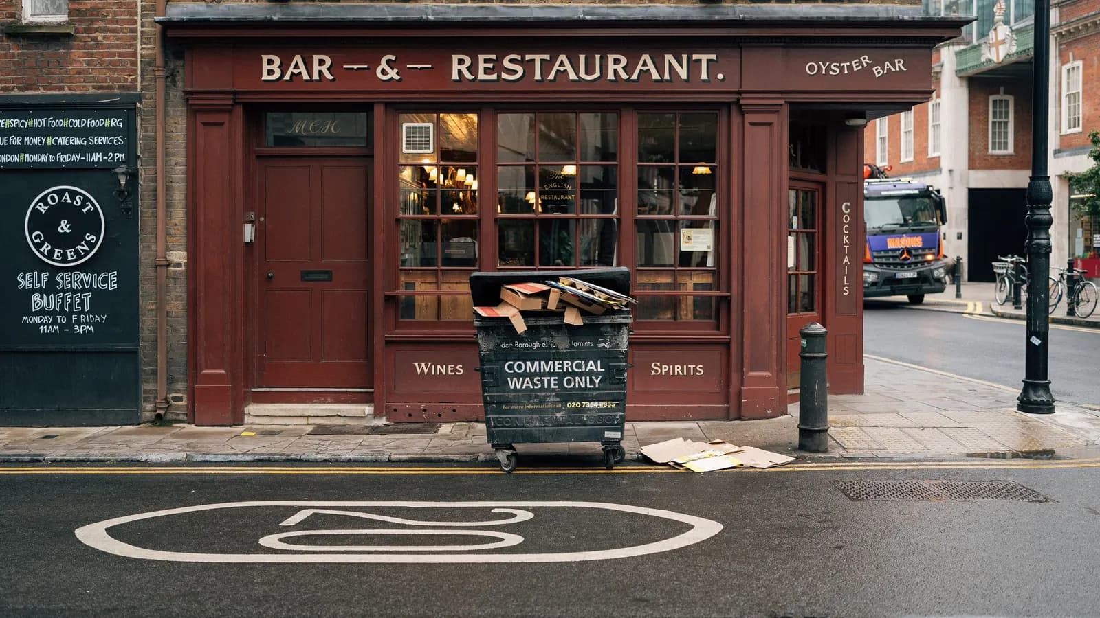Dark red timber-framed bar and restaurant frontage on a London street corner