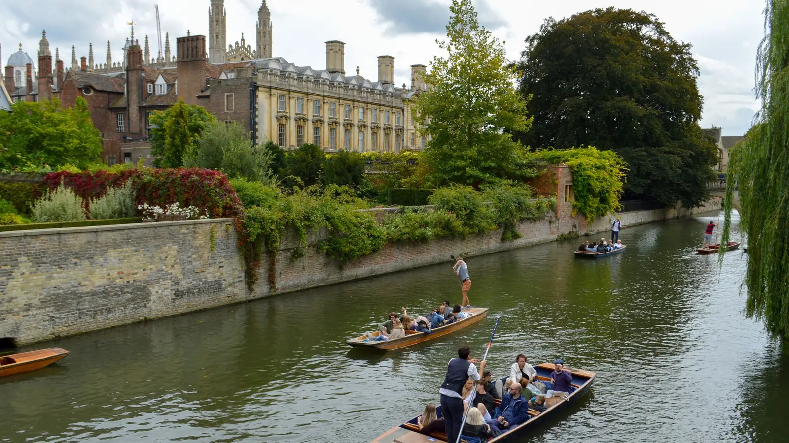 Punts on the River Cam along the Backs in Cambridge, with college buildings behind